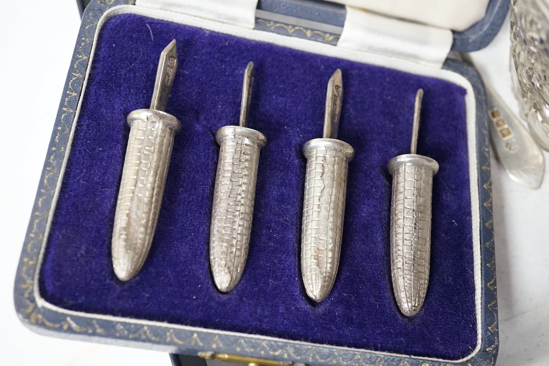 A group of small silver including a George V capstan inkwell, Birmingham, 1924, base diameter 14cm, two cigarette cases, a vesta case, a five bar toast rack, a commemorative dish, mounted glass toilet jar, a matchbook ca